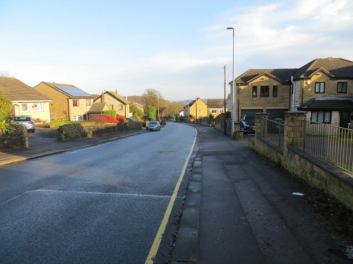 Modern stone-built detached houses along East Street in Lindley, Huddersfield