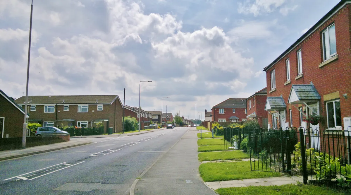 Red-brick terraced houses with porches and front lawns on Sherwood Street in Mansfield Woodhouse