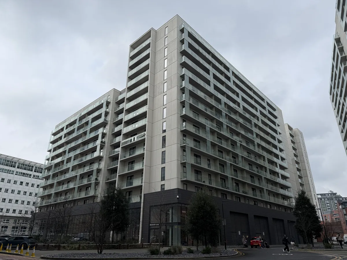 Bradshaw House, a tall block of flats with balconies at Chapel Wharf in Salford